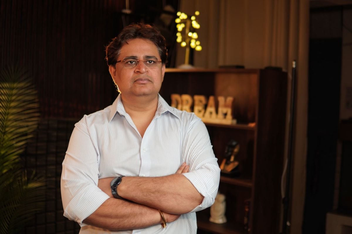 Sunil Tripathi, Astro-Vastu consultant, standing with folded arms in his consulting office